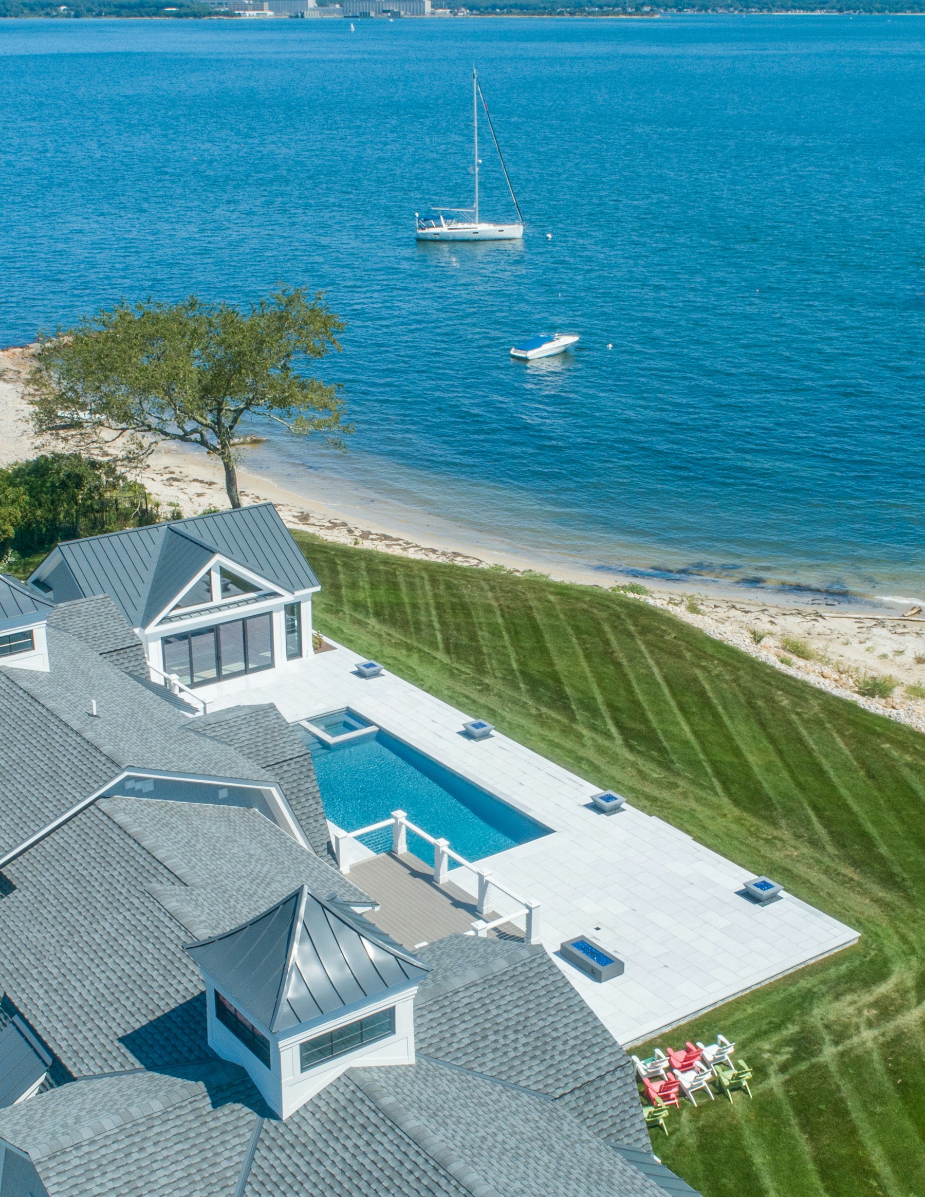 Aerial view of a waterfront estate and swimming pool